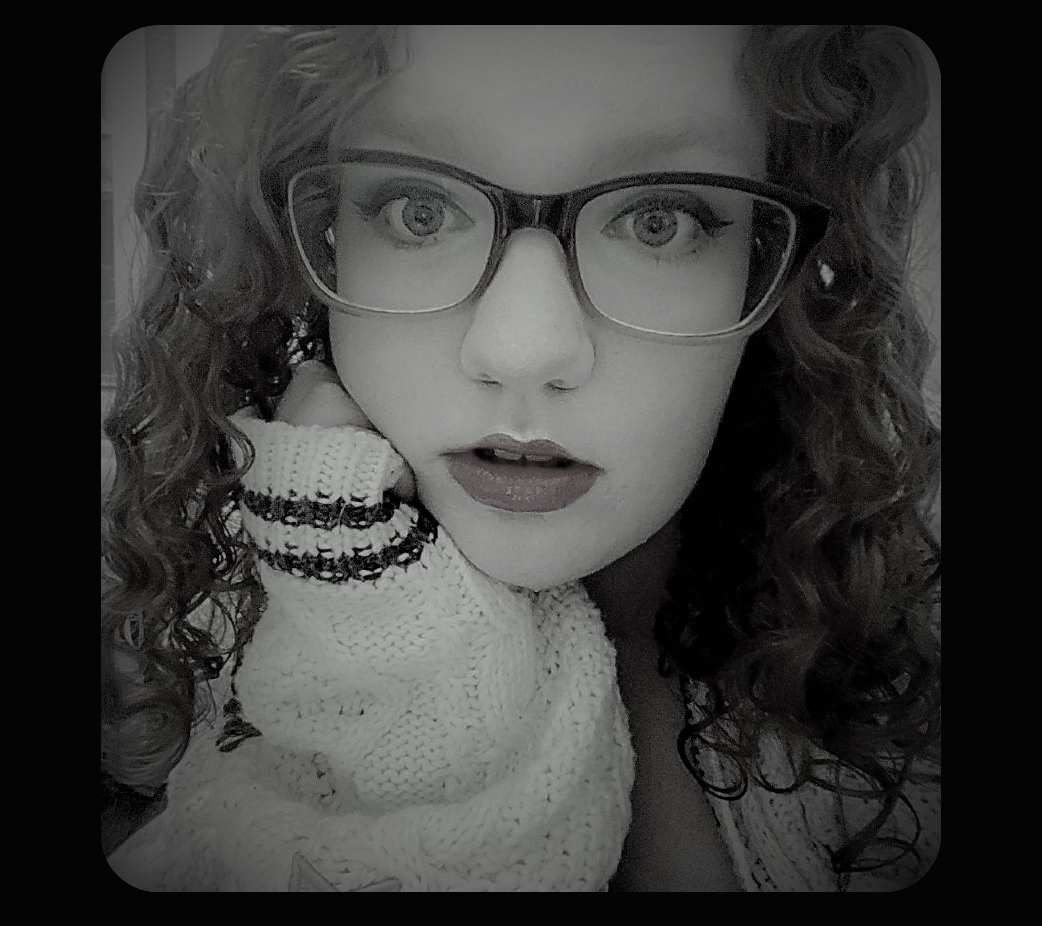 black and white photo of Kaitlin Simpson, young adult woman with glasses and curly hair
